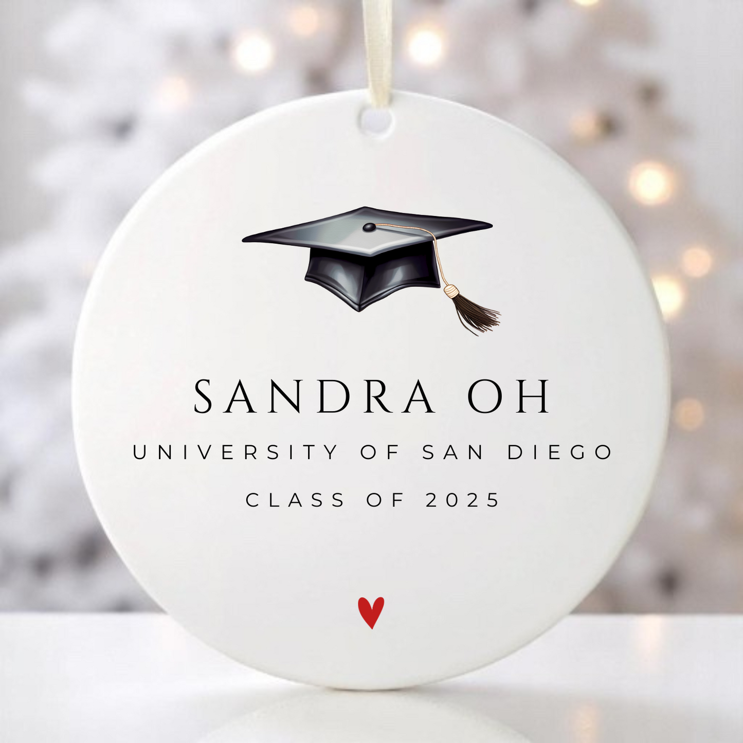A graduation ornament with graduation cap personalized with the graduate's name, school and year.