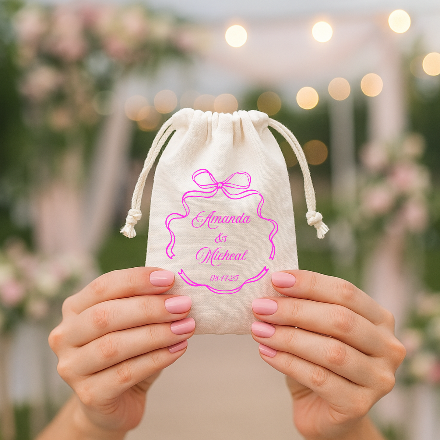 a personalized wedding favor bag with a pink bow and bride and groom's names and wedding date.