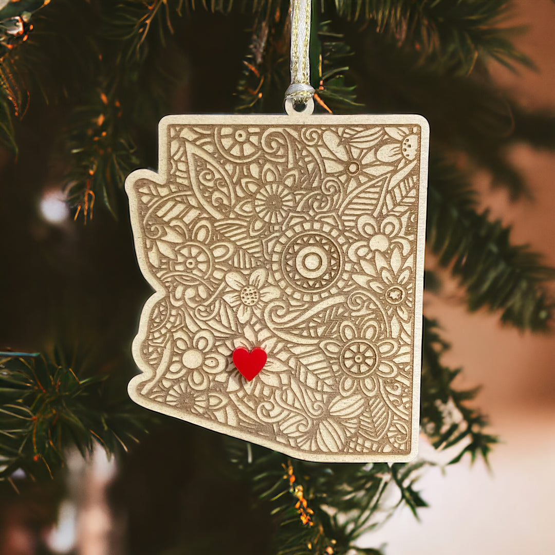 Wooden Arizona ornament with white and gold ribbon and red heart.