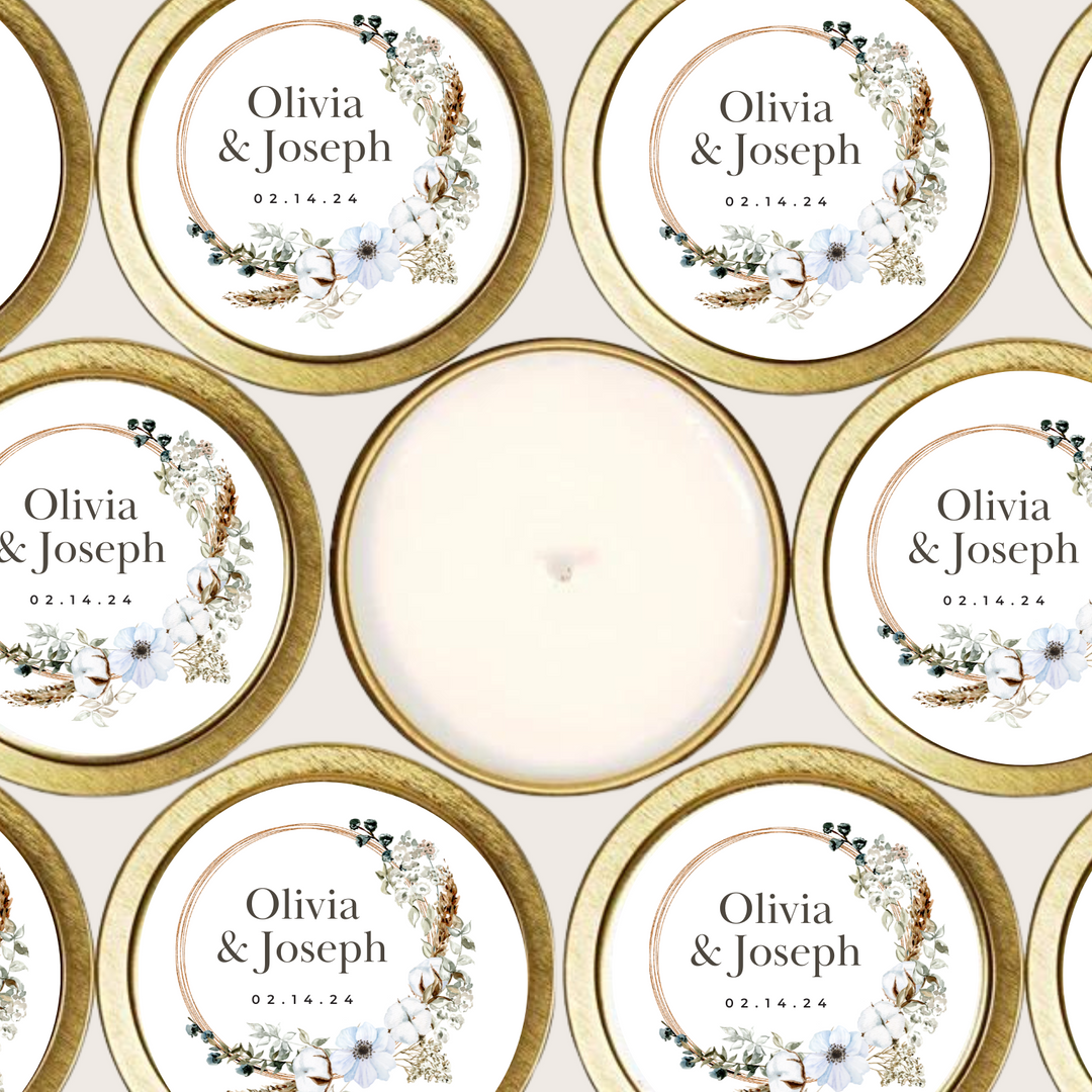 Gold tin candles with floral wreath label and couple's names and event date.