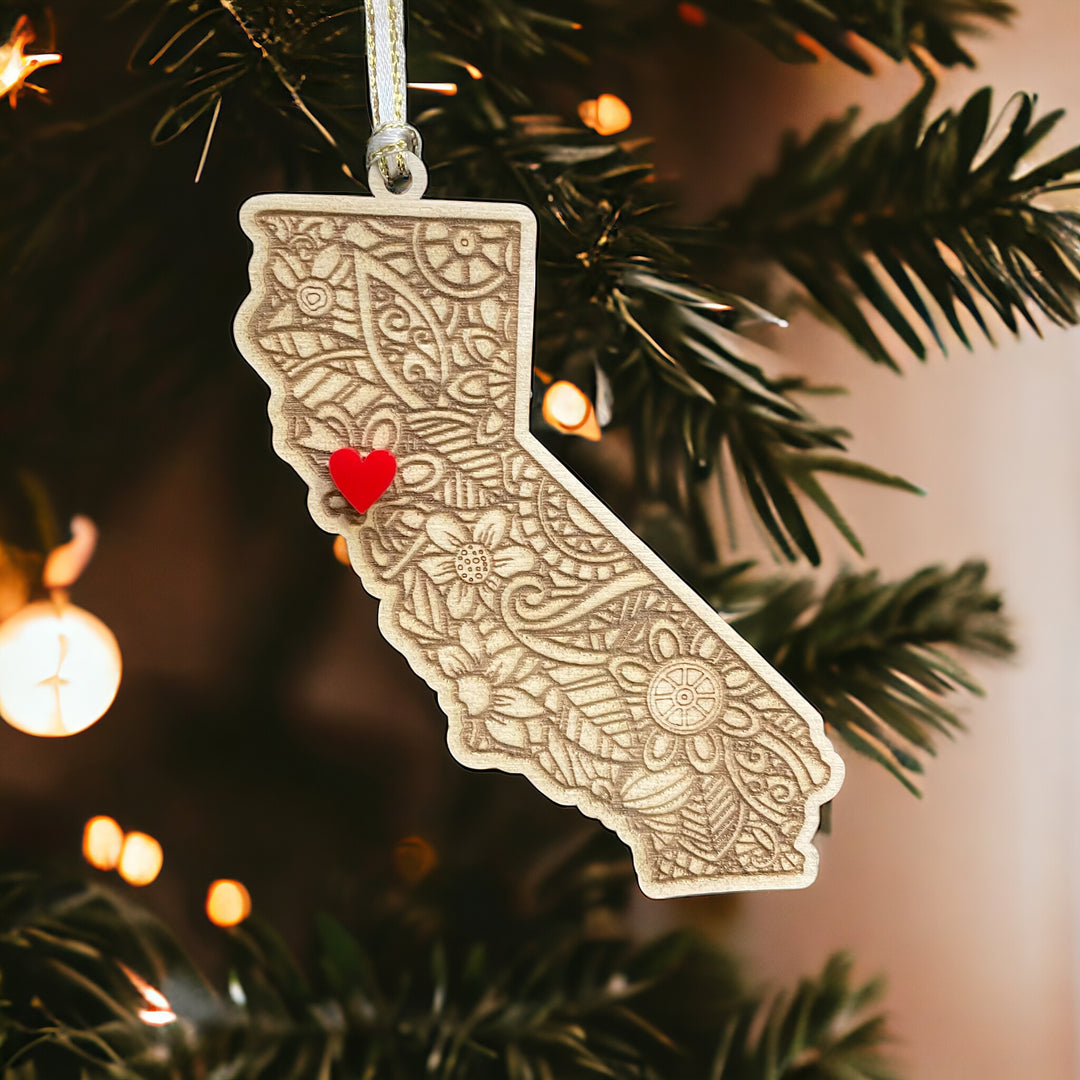 Wooden California ornament with white and gold ribbon and red heart.