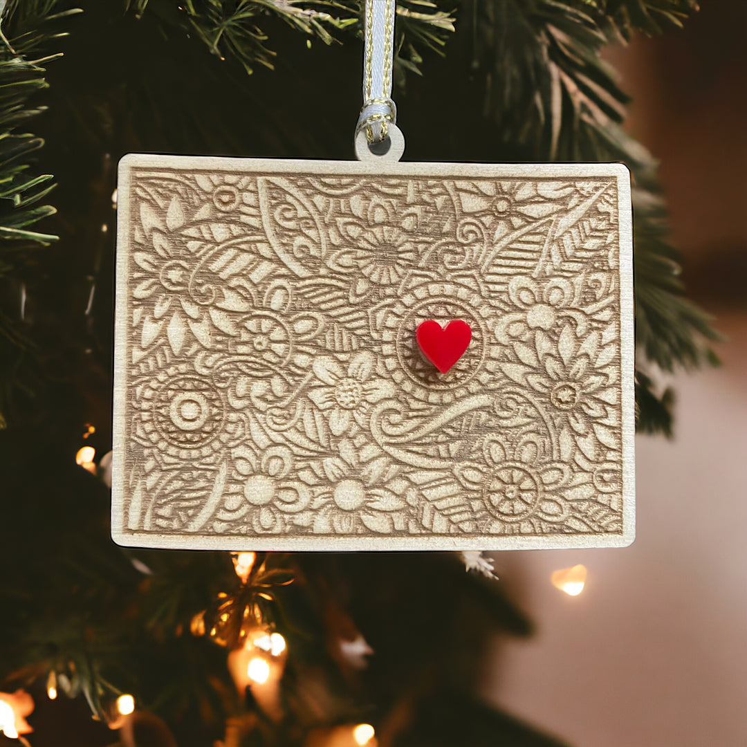 Wooden Colorado ornament with white and gold ribbon and red heart.