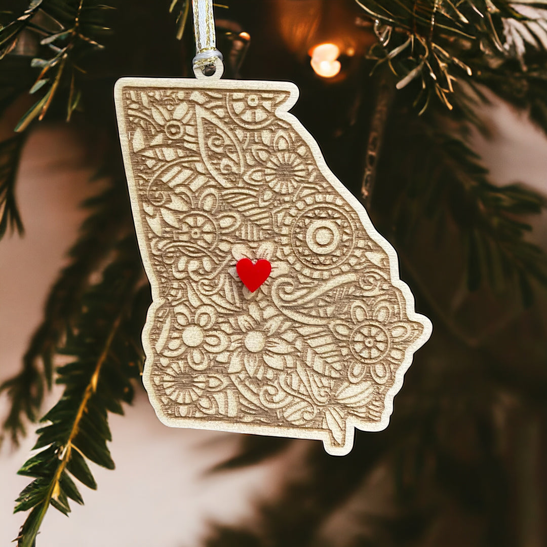 Wooden Georgia ornament with white and gold ribbon and red heart.