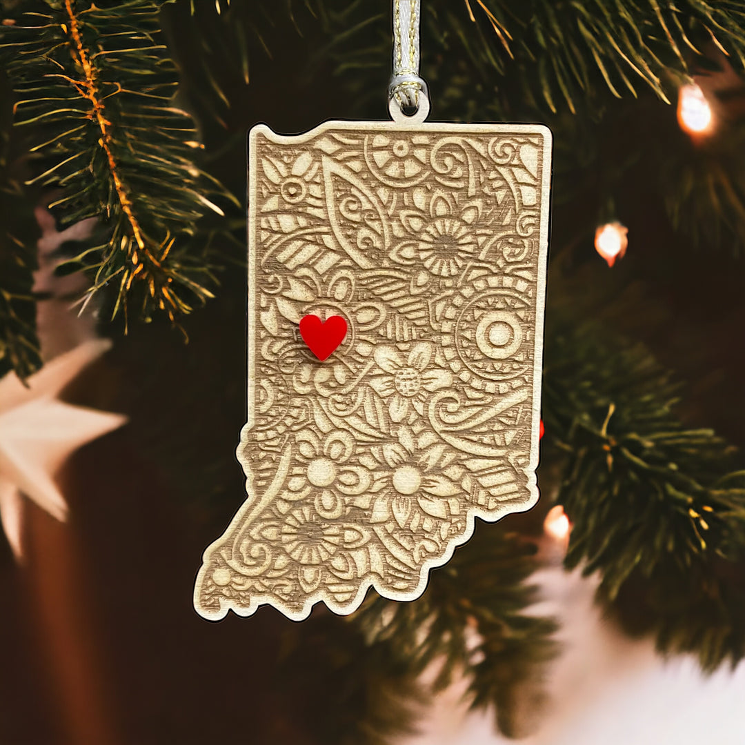 Wooden Indiana ornament with white and gold ribbon and red heart.