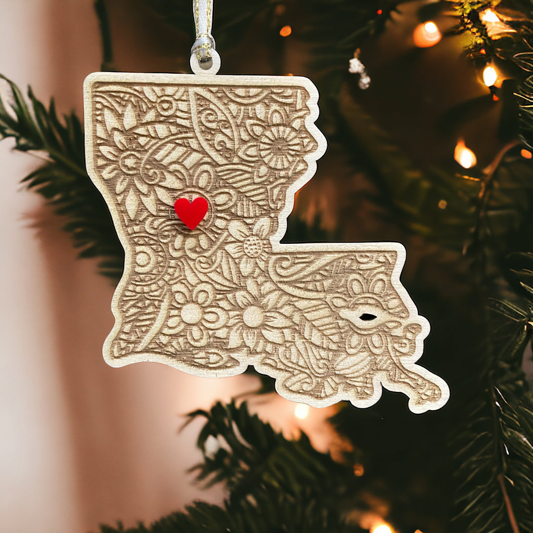 Wooden Kansas ornament with white and gold ribbon and red heart.