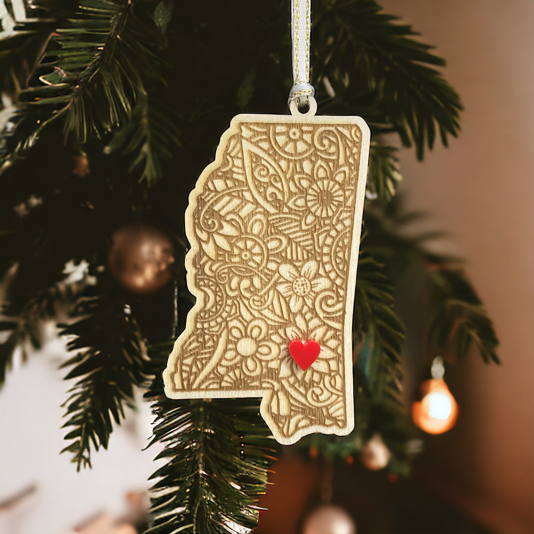 Wooden Mississippi ornament with white and gold ribbon and red heart.