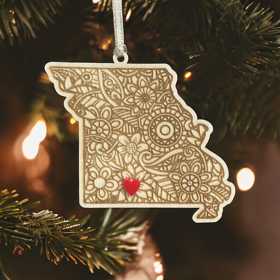 Wooden Missouri ornament with white and gold ribbon and red heart.