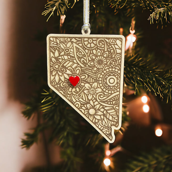 Wooden Nevada ornament with white and gold ribbon and red heart.