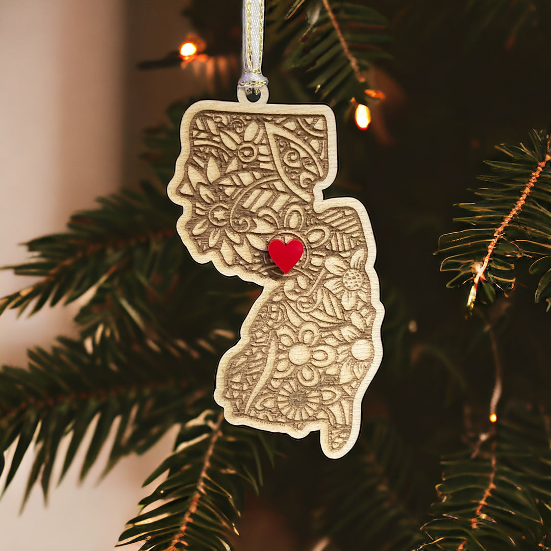 Wooden New Jersey ornament with white and gold ribbon and red heart.