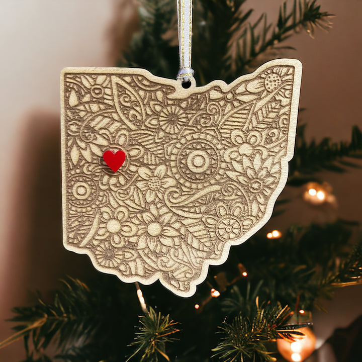 Wooden Ohio ornament with white and gold ribbon and red heart.