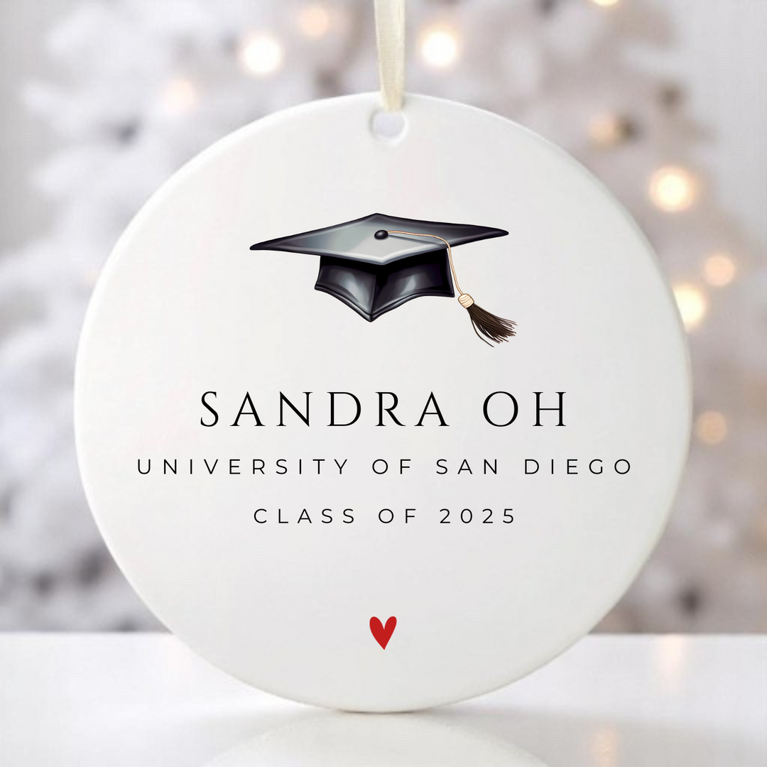 A graduation ornament with graduation cap personalized with the graduate's name, school and year.