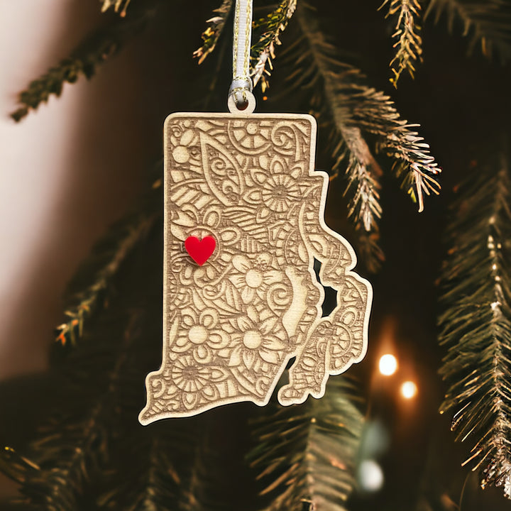 Wooden Rhode Island ornament with white and gold ribbon and red heart.