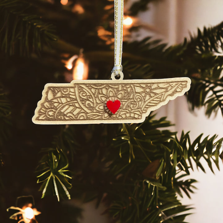 Wooden Tennessee ornament with white and gold ribbon and red heart.