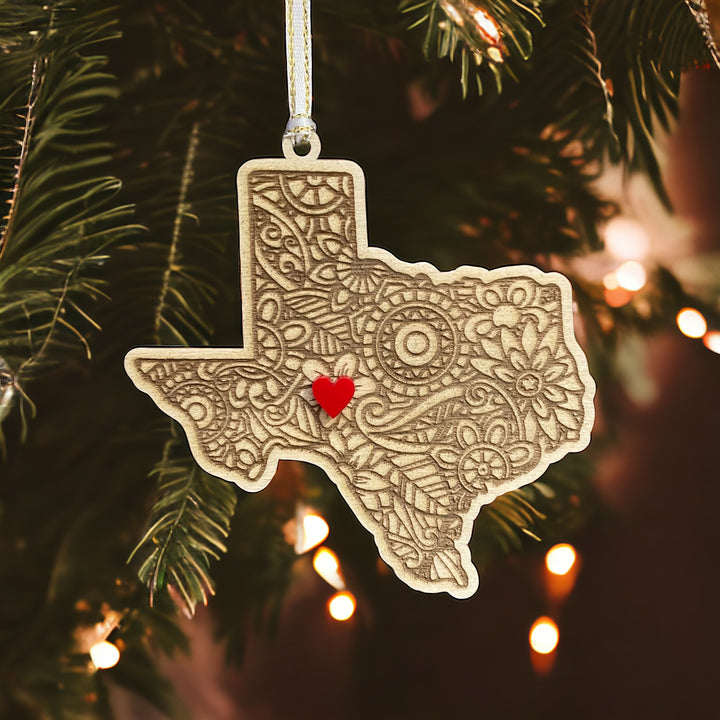 Wooden Texas ornament with white and gold ribbon and red heart.