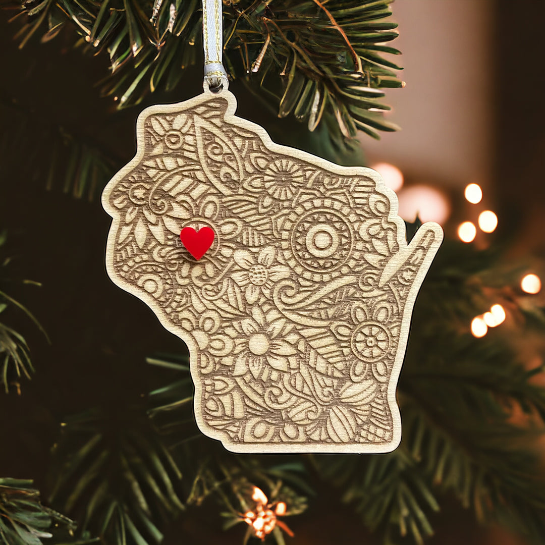 Wooden ornament of Wisconsin with mandala pattern and red heart.