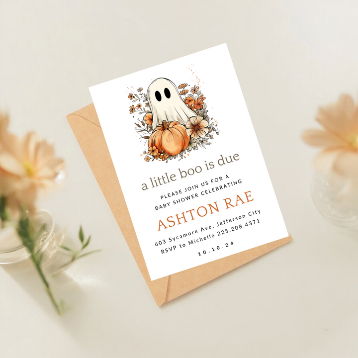 A baby shower invitation with a ghost and floral pumpkin design