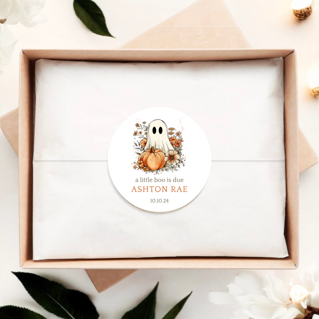 A gift box with a ghost and floral pumpkin label.