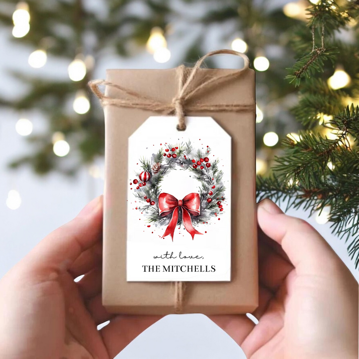 A small gift with a personalized Christmas tag with green wreath.