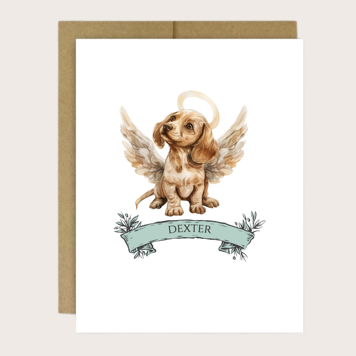 A dachshund puppy with halo and wings and the puppies name.