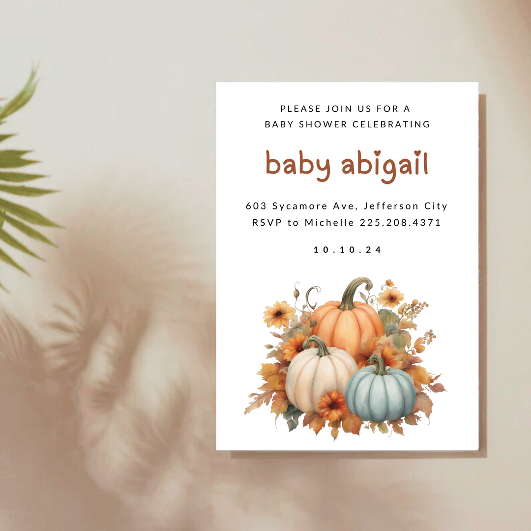 A baby shower invitation with a floral pumpkin design.