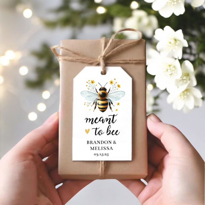 Brown gift box with gift tag with bee that says meant to bee and the couple's names and event date.