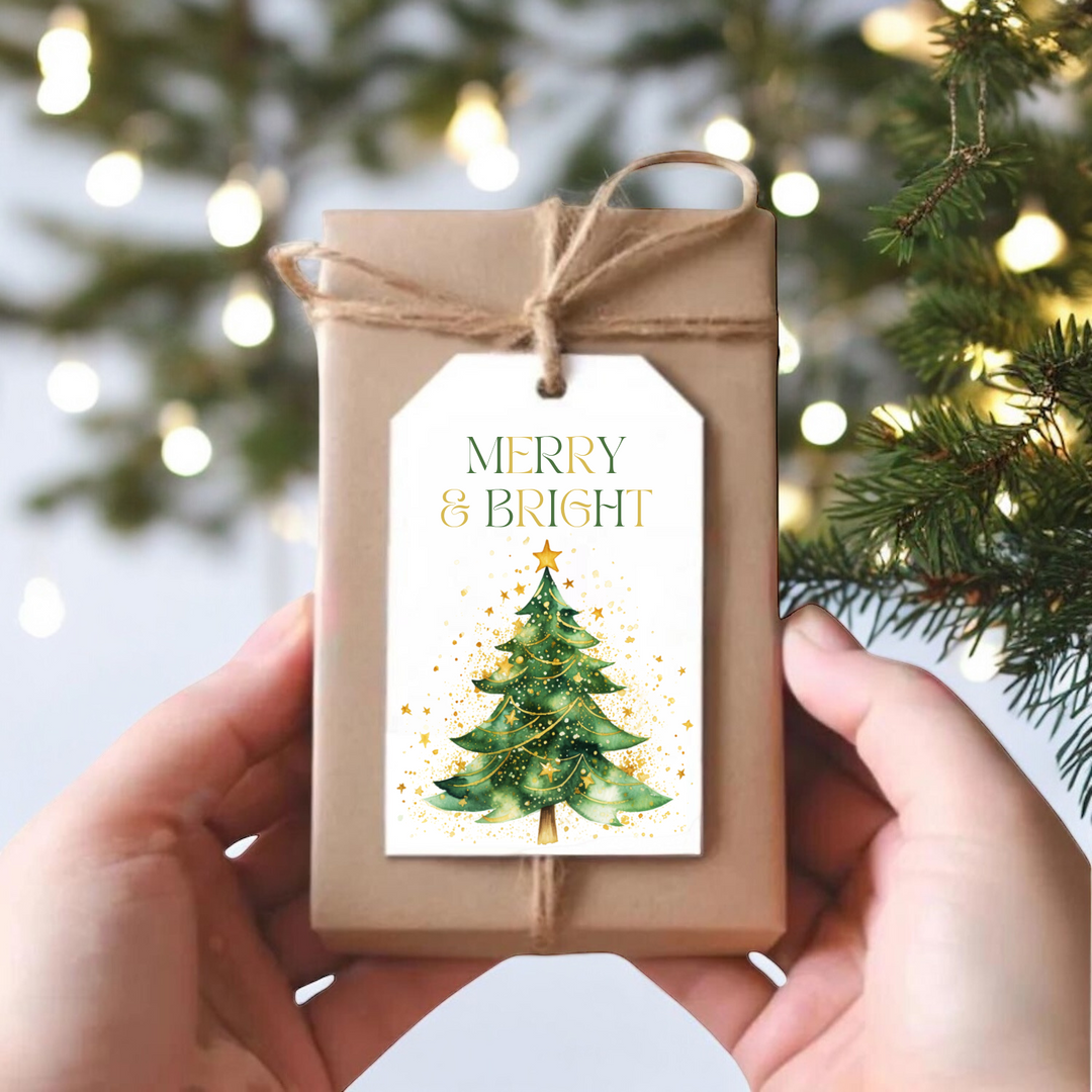 A small gift box with a green and gold Christmas tree and the sentiment "Merry and Bright."
