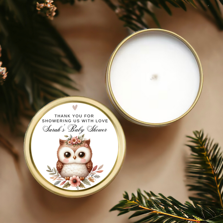 A gold tin candle with a personalized floral owl label.