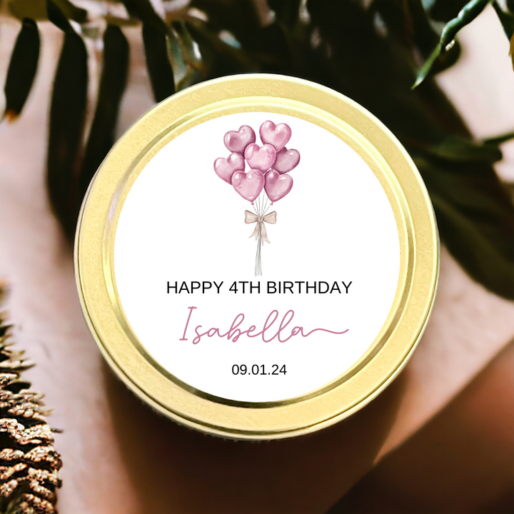 Gold tin candle with pink balloons and personalization.