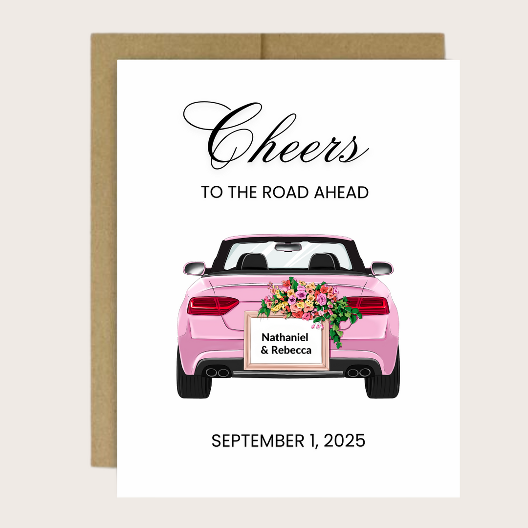 A personalized greeting card with a pink convertible and "Cheers to the road ahead!"