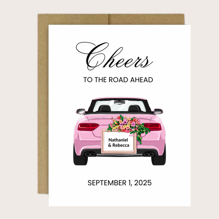 A personalized greeting card with a pink convertible and "Cheers to the road ahead!"