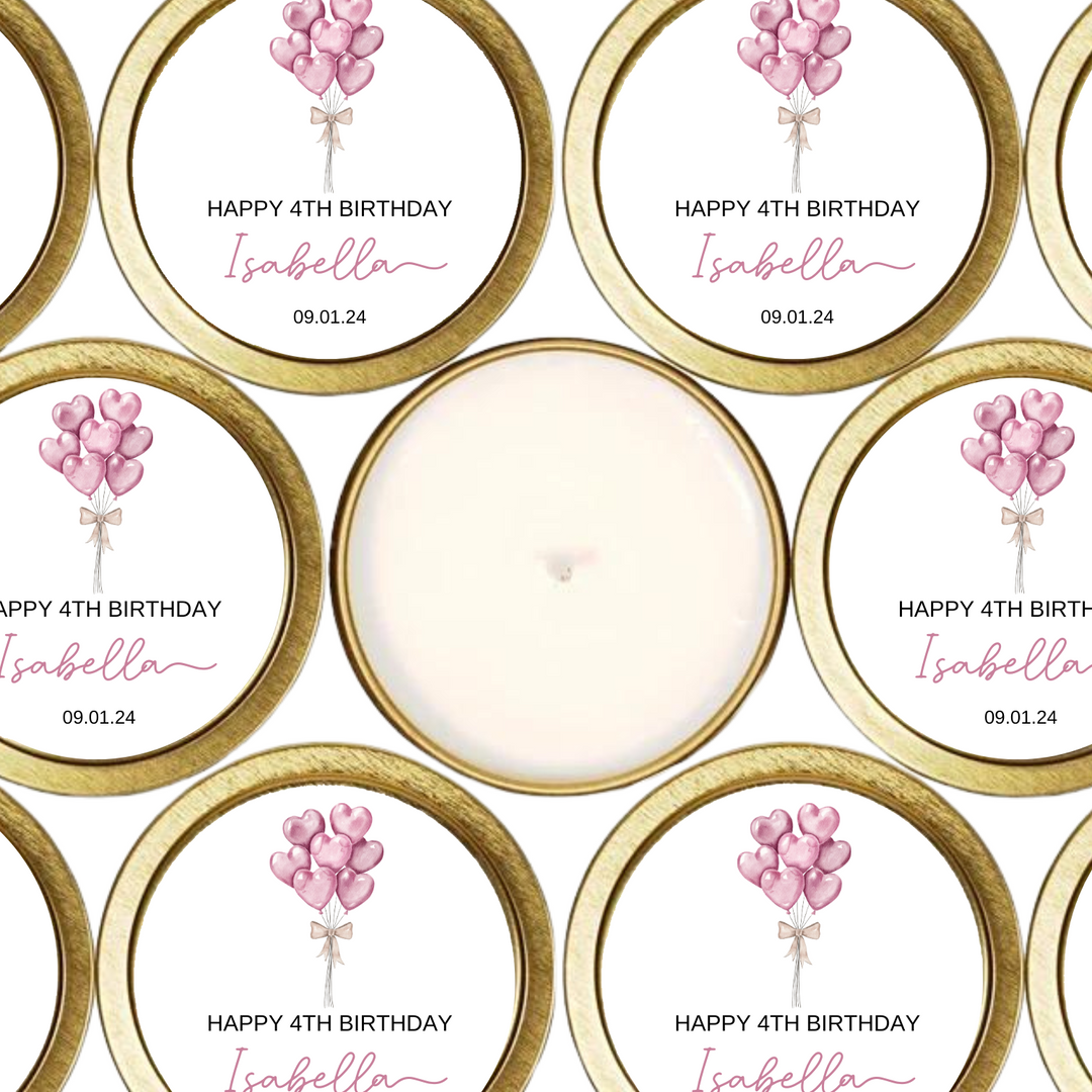 Gold tin candles with labels with pink heart balloons.