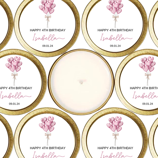 Gold tin candles with labels with pink heart balloons.