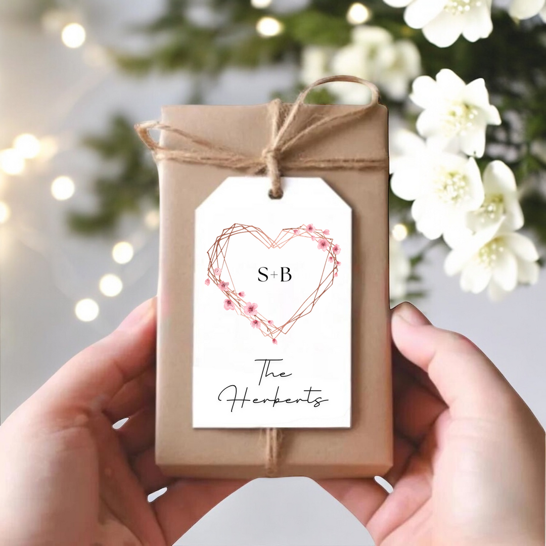 A gift box with a personalized pink heart gift tag.