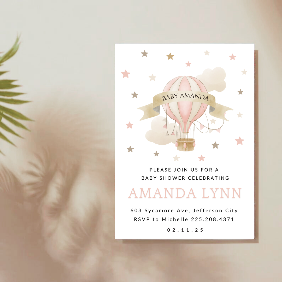 Baby shower invitation with pink hot air balloon.