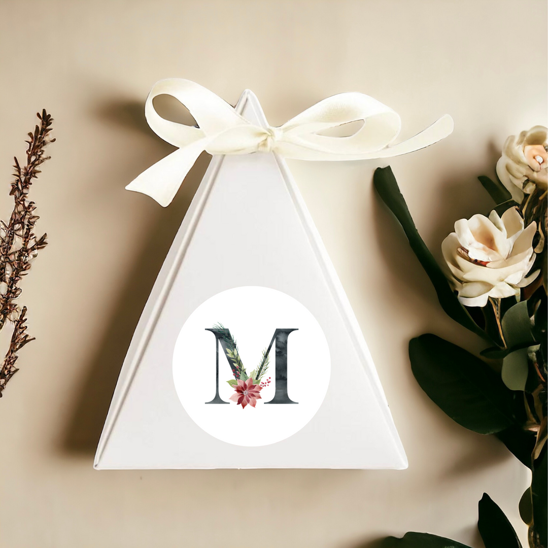 A triangular gift box with a bow at the top and a personalized label in the middle.