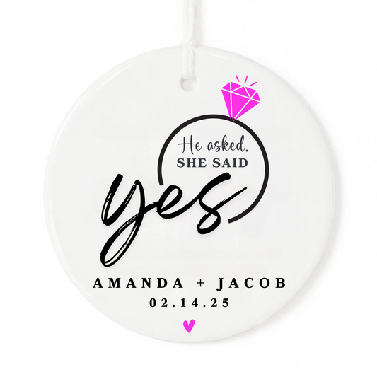 A white Christmas ornament keepsake gift with a diamond, bride and grooms names and date.