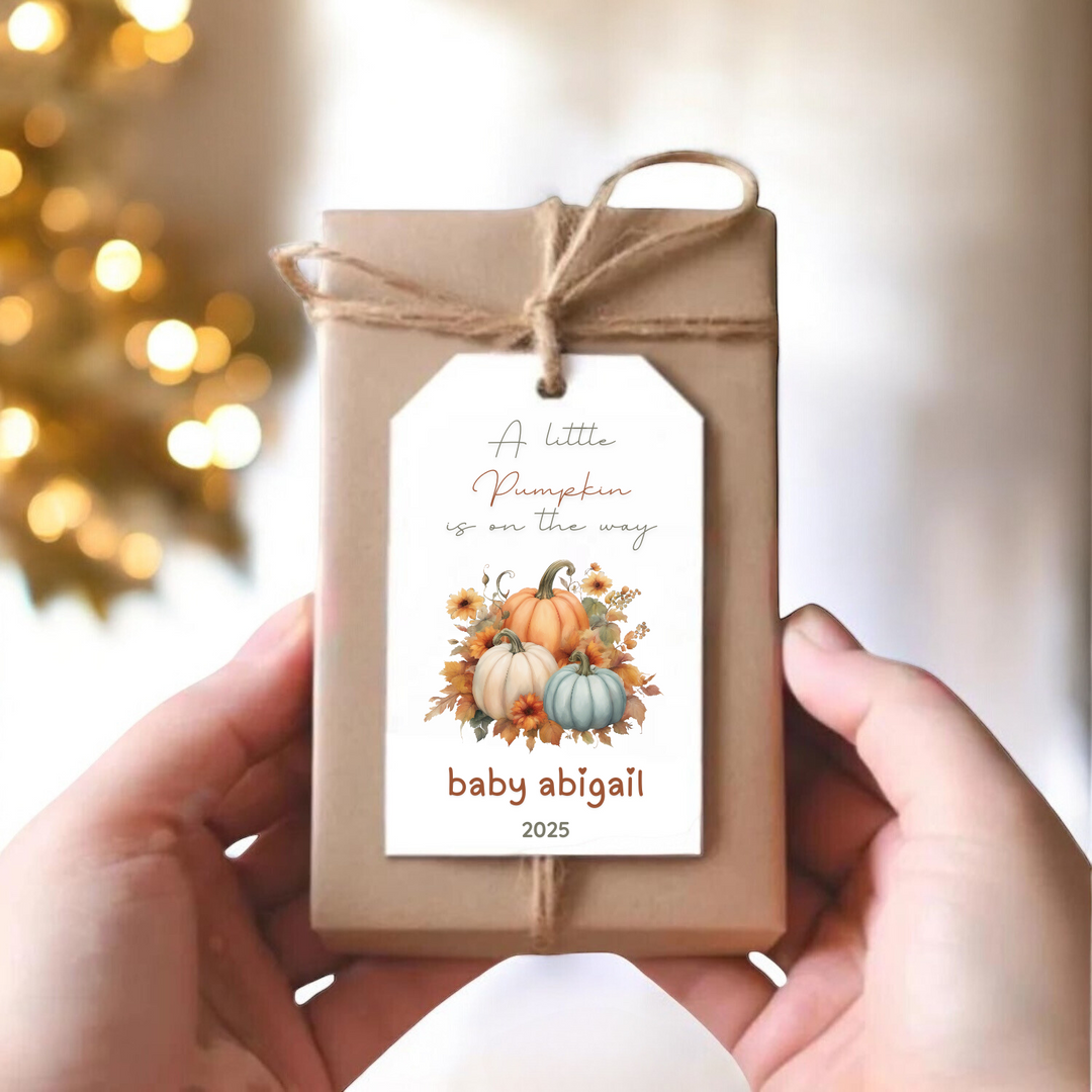 A small gift box with a personalized gift tag with fall pumpkins.