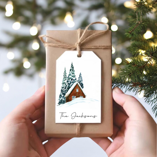 A small gift box with a snowy cabin scene.