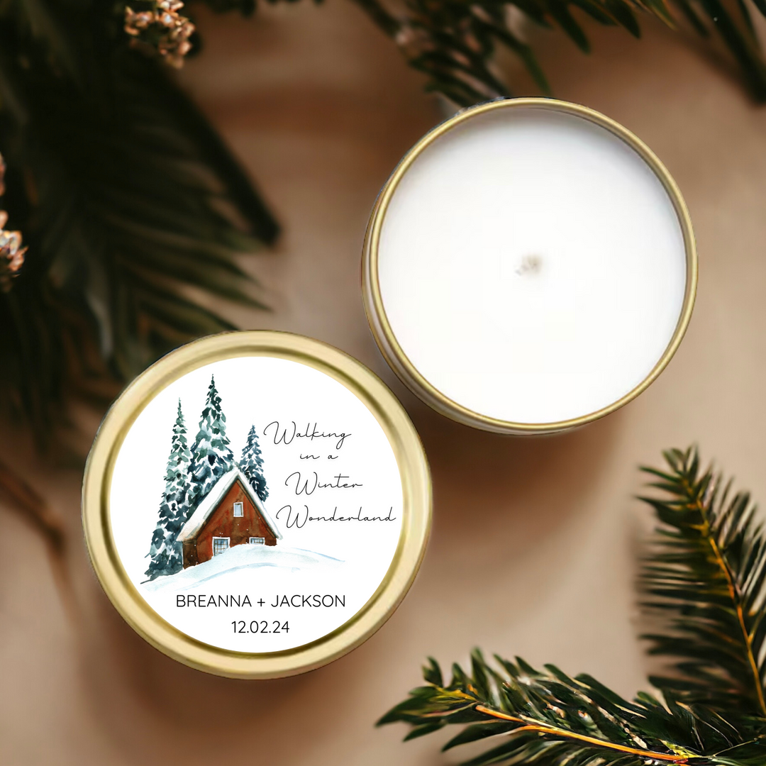 A gold tin candle with a personalized winter-themed label.