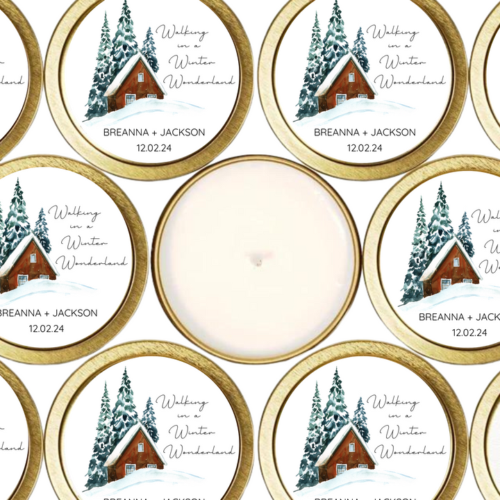 Gold tin candles with a winter scene and the couple's names and wedding date. Walking in a Winter Wonderland